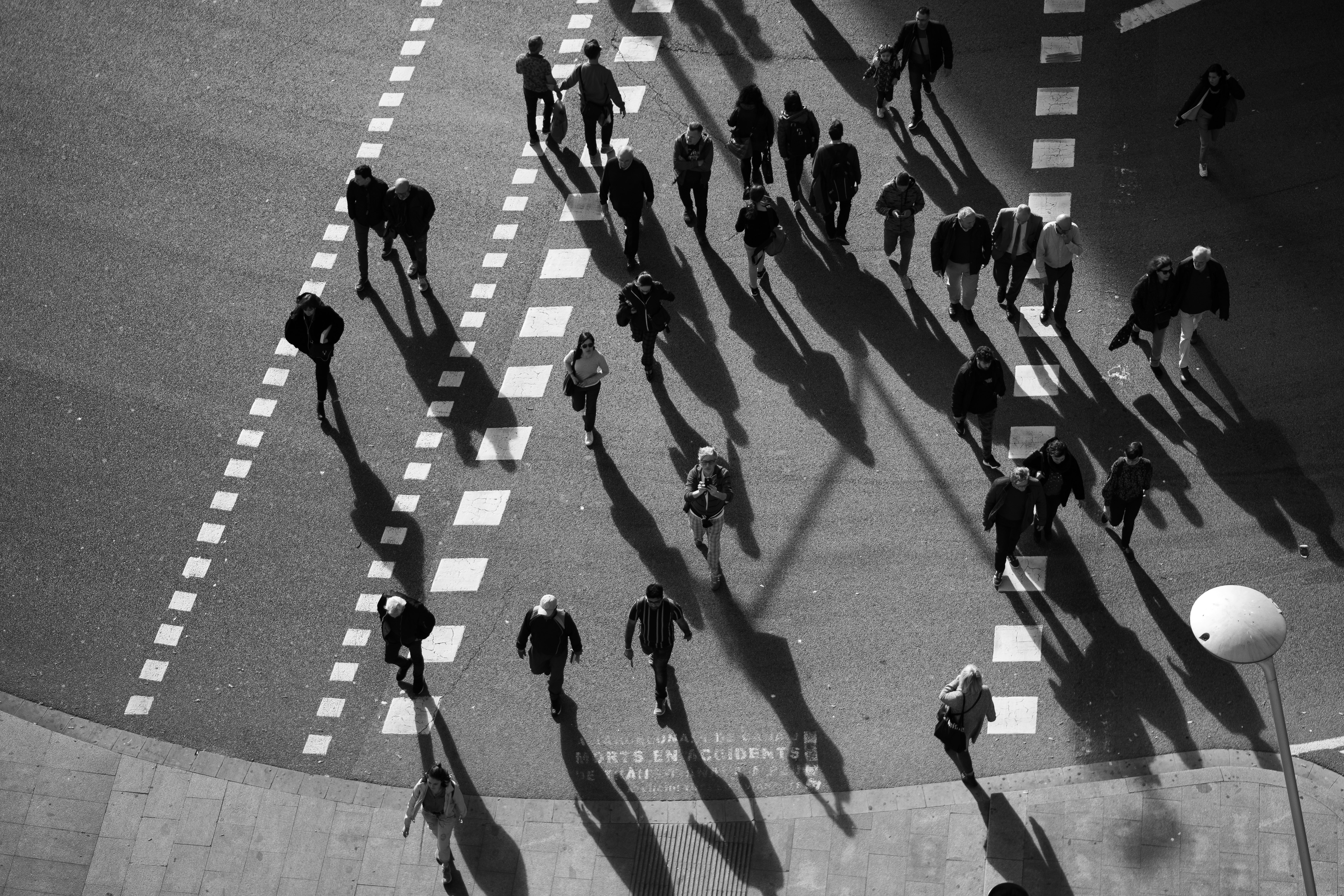 people walking on pedestrian lane in grayscale photography